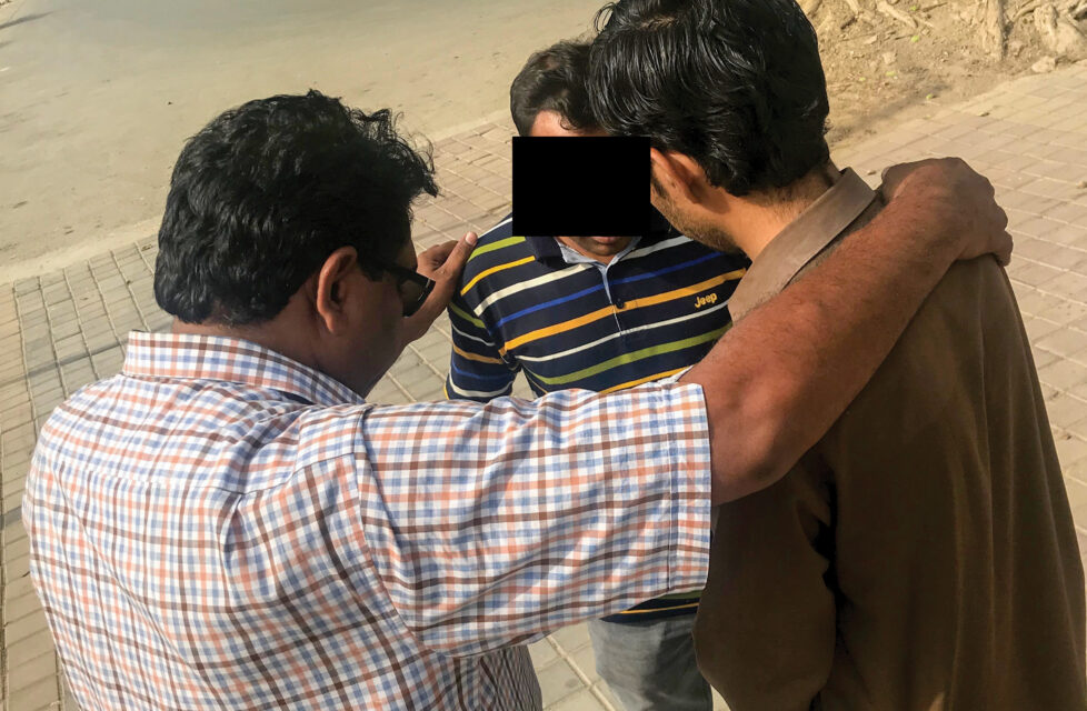 Three men praying together