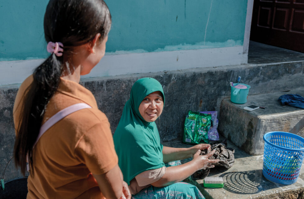 indonesian woman talks to woman in hijab