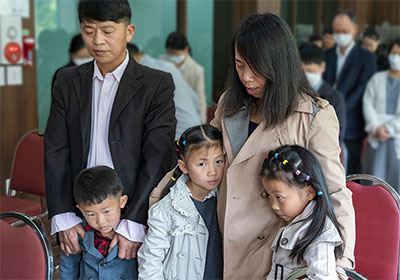 Family praying during church service